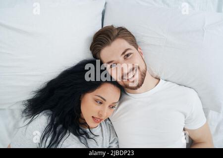 Happy lady and her beloved man resting in bedroom Stock Photo