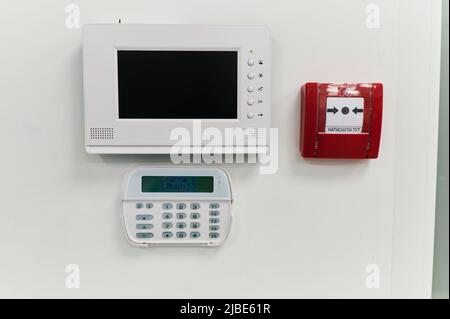 alarm control keyboard, wall-mounted indoor monitor for video surveillance, fire alarm button Stock Photo