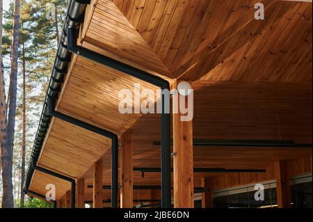 The roof of an open veranda made of wood trim with plastic pipes for ...