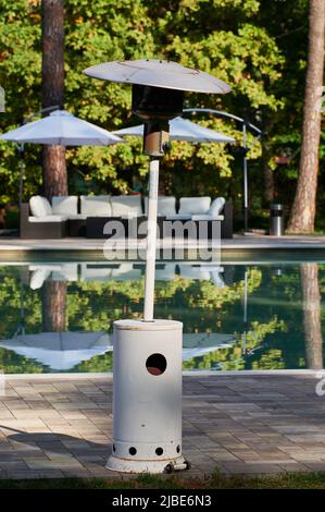 outdoor gas burner heater with a reflective element for outdoor heating of a recreation area Stock Photo
