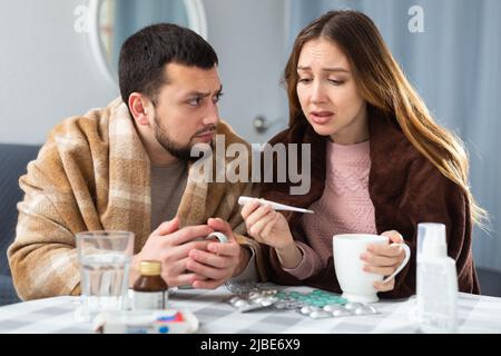 Sick couple suffering from flu at home Stock Photo