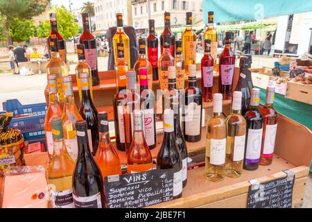 Selection of French and Corsican wine on stall, Marcatu d'Aiacciu, Boulevard du Roi Jerome, Ajaccio Corsica (Corse), Corse-du-Sud, France Stock Photo