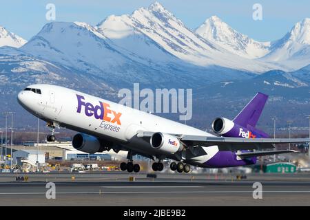Fedex McDonnell Douglas MD-11 aircraft taking off. Plane for cargo transport for Federal Express. Aircraft departing Anchorage Airport. Stock Photo