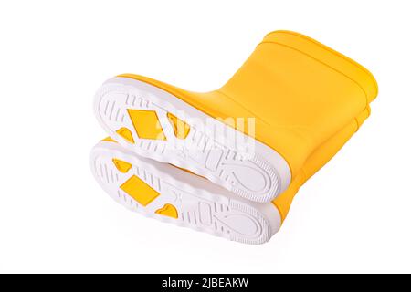 Yellow rubber boots isolated on white background. Kids shoes. Stock Photo