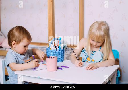 Kids painting together on a large piece of paper Stock Photo - Alamy