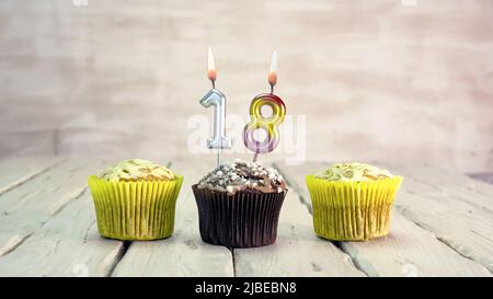 Happy birthday muffins with candles with the number. Card copy space with pies for congratulations. Stock Photo