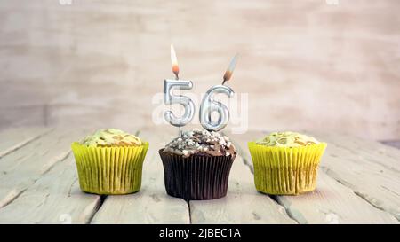 Happy birthday muffins with candles with the number. Card copy space with pies for congratulations. Stock Photo