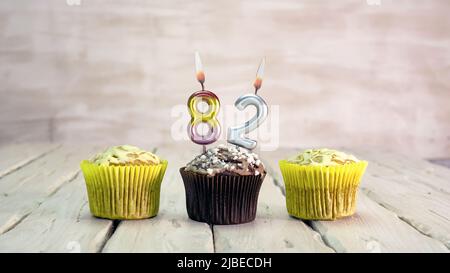 Happy birthday muffins with candles with the number. Card copy space with pies for congratulations. Stock Photo