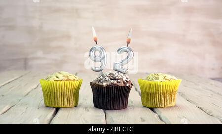 Happy birthday muffins with candles with the number. Card copy space with pies for congratulations. Stock Photo