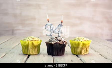 Happy birthday muffins with candles with the number. Card copy space with pies for congratulations. Stock Photo