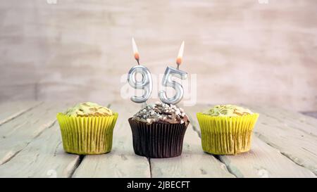 Happy birthday muffins with candles with the number. Card copy space with pies for congratulations. Stock Photo