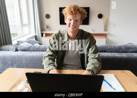 Young british man studying online or having business video conference on laptop Stock Photo