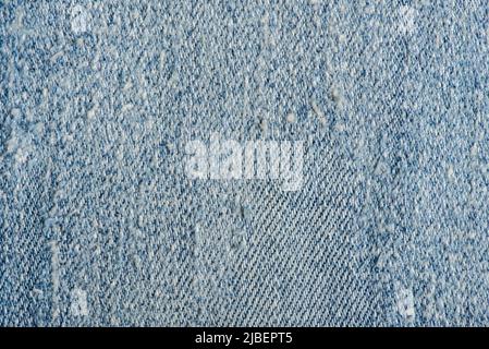 Old blue denim jeans texture. Scratched denim jeans. Fashion blue denim jeans. Stock Photo