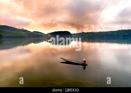 Dawn on Son Tho Lake. This lake is located in Son Tho village, Son Tra town, Hue city. This place is about 20 km from the city center. This is a campi Stock Photo