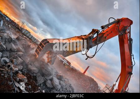 Excavator with concrete crusher on rig at demolition site Stock Photo ...