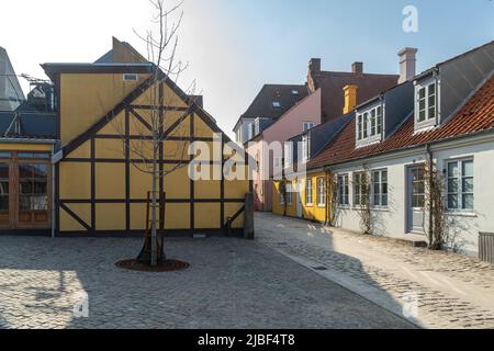 Traditional half-timbered warehouses and old yellow houses in the historic city center of Odense. Odense, Fyn, Denmark, Europe Stock Photo