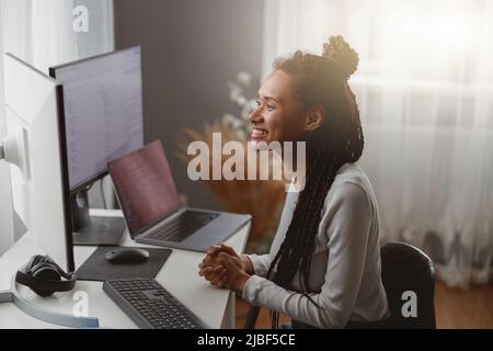 Happy smiling professional female programmer works from home, pretty IT developer woman Stock Photo