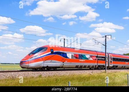 A Frecciarossa (ETR 1000) high speed train from italian rail company Trenitalia is driving from Lyon to Paris on the LGV Sud-Est in the countryside.