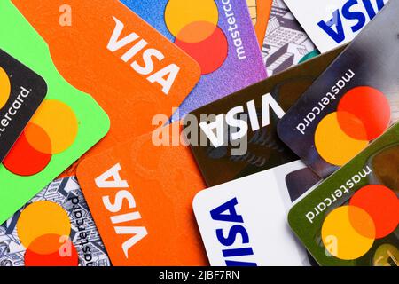A close-up view of a Mastercard credit card and a debit card seen ...