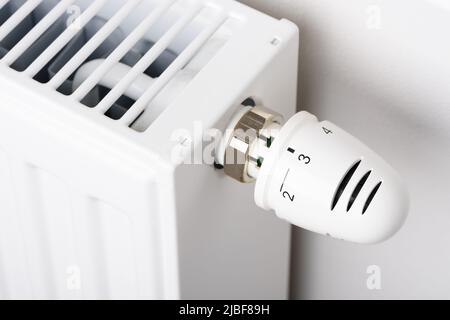 Valve knob of heating radiator temperature thermostat in winter cold season Stock Photo