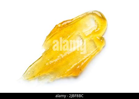 Golden honey or clear yellow gel serum smear with bubbles isolated on white background top view Stock Photo