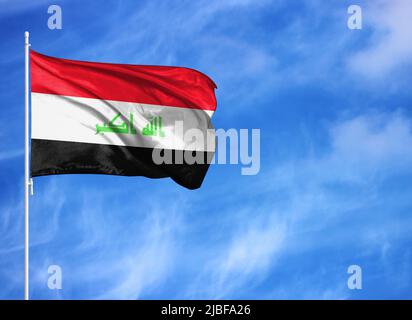 National flag of Iraq on a flagpole Stock Photo