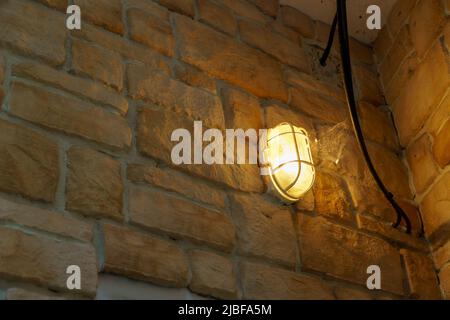 Electric lantern on a brick or stone wall Stock Photo