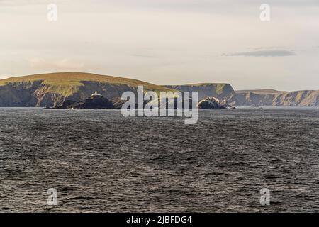 The lighthouse at Muckle Flugga is situated on the most northerly rock in the Shetland Isles Stock Photo