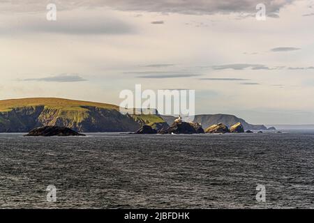 The lighthouse at Muckle Flugga is situated on the most northerly rock in the Shetland Isles Stock Photo