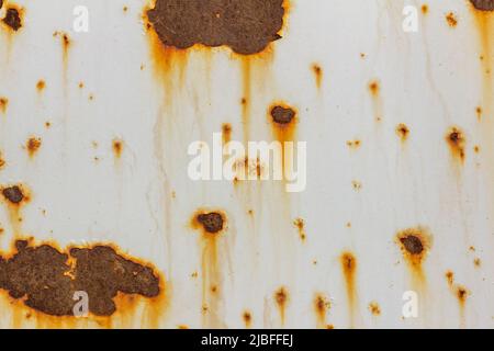 Rusty metal surface with white cracked paint. Rusty old metal. Metal covered with rust.The old rusty hood of the car. Stock Photo