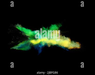 Various multicolored forms of powder paint explode in front of a black ...