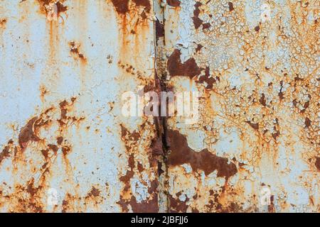 Rusty metal surface with blue cracked paint. Old rusty metal. Metal covered with rust Stock Photo