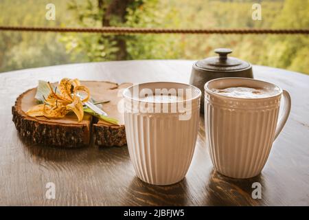 Tasty coffee served in the garden on old wooden table Stock Photo