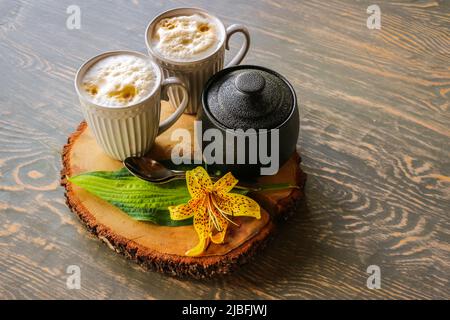 Tasty coffee served in the garden on old wooden table Stock Photo