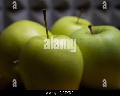 Four large apples, close-up. Fruit on a wooden surface. Stock Photo