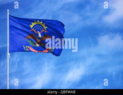 National flag of State of North Dakota on a flagpole Stock Photo