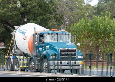 An image from in front and beside of a Hanson Concrete Mixer truck moving on a Pennant Hills Road, Normanhurst in Sydney, Australia Stock Photo