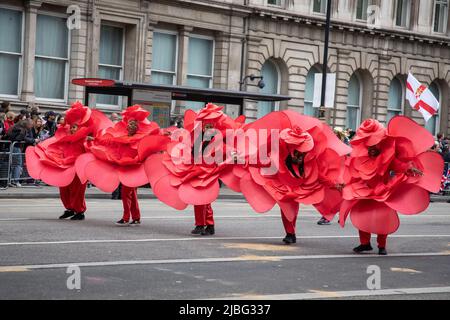 London, UK. 5th June 2022. Performers dressed as roses were part of the 7-thousand-people strong Platinum Jubilee Pageant held in central London to mark her Majesty's 70 years on the throne. The colourful parade made its way along Whitehall, the Mall and past Buckingham Palace and was described by many as a once in a lifetime event. Credit: Kiki Streitberger / Alamy Live News Stock Photo