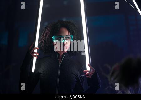 Metaverse digital cyber world technology, young woman with smart glasses, futuristic lifestyle Stock Photo