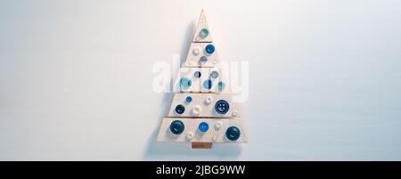 Little cute wooden toy Christmas tree on white background Stock Photo