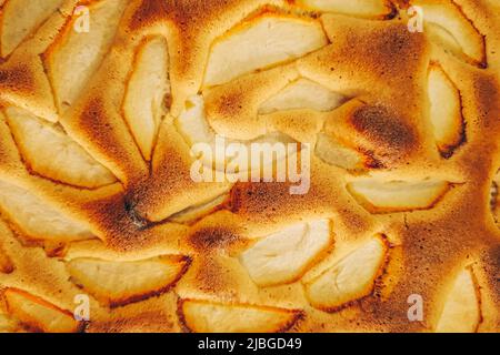 Apple pie close up. Texture of fresh baking. Pieces of fruit in a baked dough. Stock Photo