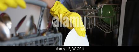 Persons hand in glove take plate Stock Photo