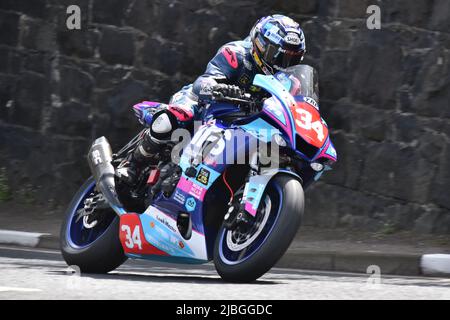 Champion motorcycle racer Alastair Seeley shoots out under the railway bridge heading up Black Hill at the 2022 North West 200 international races Stock Photo