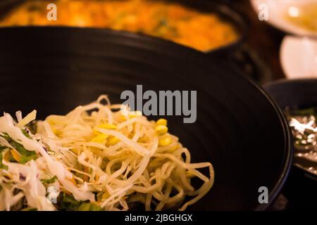 Namul (bean sprouts and shredded cabbage) & Korean cuisines in the restaurant, Daegu, South Korea. Namul is Korean food seasoned herbal dishes Stock Photo