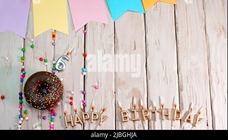 Birthday with number. Donut on the festive table. Happy birthday congratulations top view. Happy birthday card with beautiful decorations on a white Stock Photo