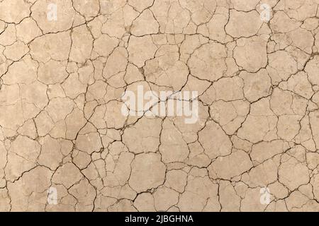 Close of a photo of seamless cracked soil. Concept of drought and climate change. Stock Photo