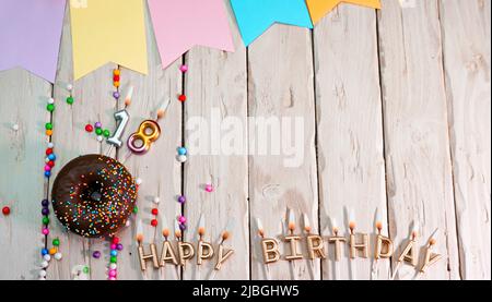 Birthday with number. Donut on the festive table. Happy birthday congratulations top view. Happy birthday card with beautiful decorations on a white Stock Photo