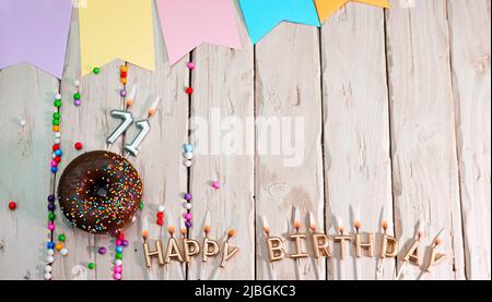 Birthday with number. Donut on the festive table. Happy birthday congratulations top view. Happy birthday card with beautiful decorations on a white Stock Photo