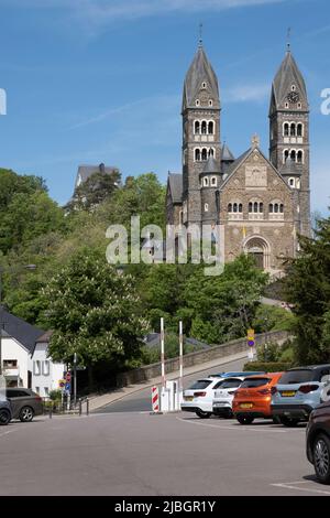 Facade of the 19th Century Neo Romanesque Clervaux Abbey, Monastery of Saint-Maurice and Saint-Maur Benedictines in Luxembourg in summer Stock Photo