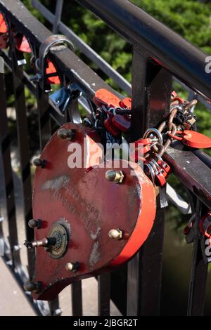 Little and big red love padlocks in the shape of hearts attached to a fence in little Venice district of Colmar, Alsace, France Stock Photo